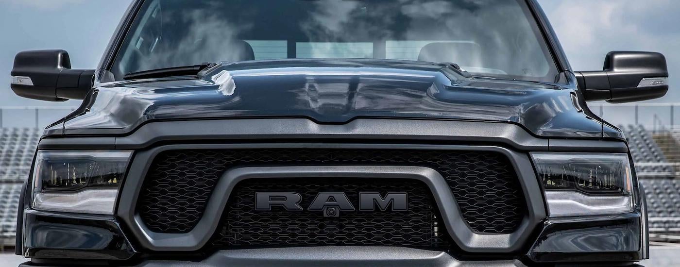 A close up of the grille and front of a black 2023 Ram 1500 Rebel is shown.