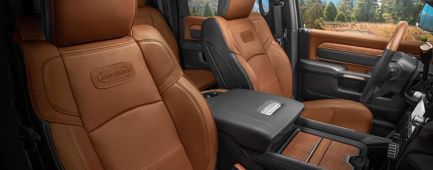 The brown and black leather interior in a 2021 Ram 2500 Limited Longhorn is shown.